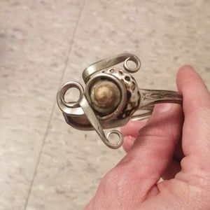 Unique silver fork with shell bracelet.